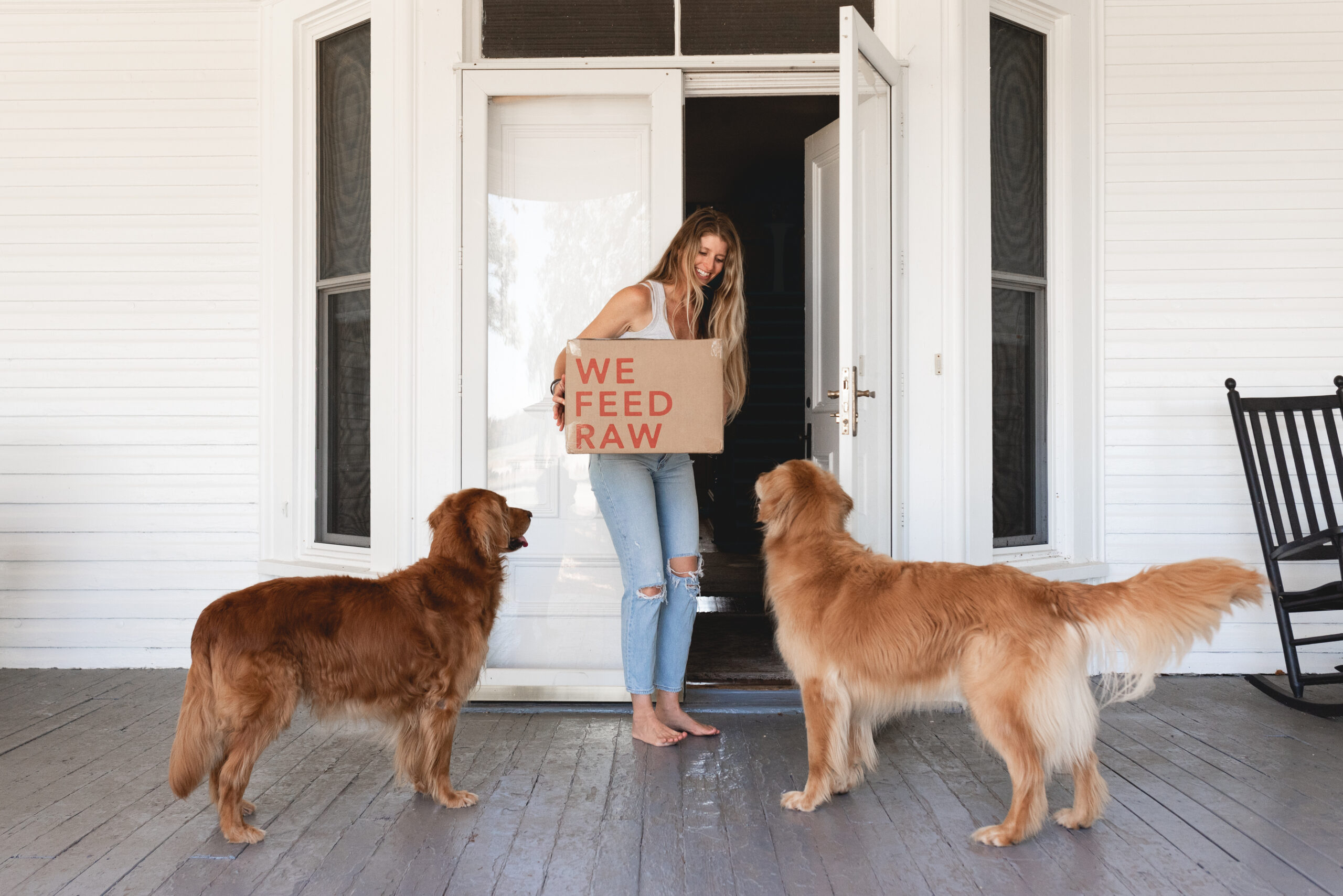 Package of HPP Raw pet food being given to dogs